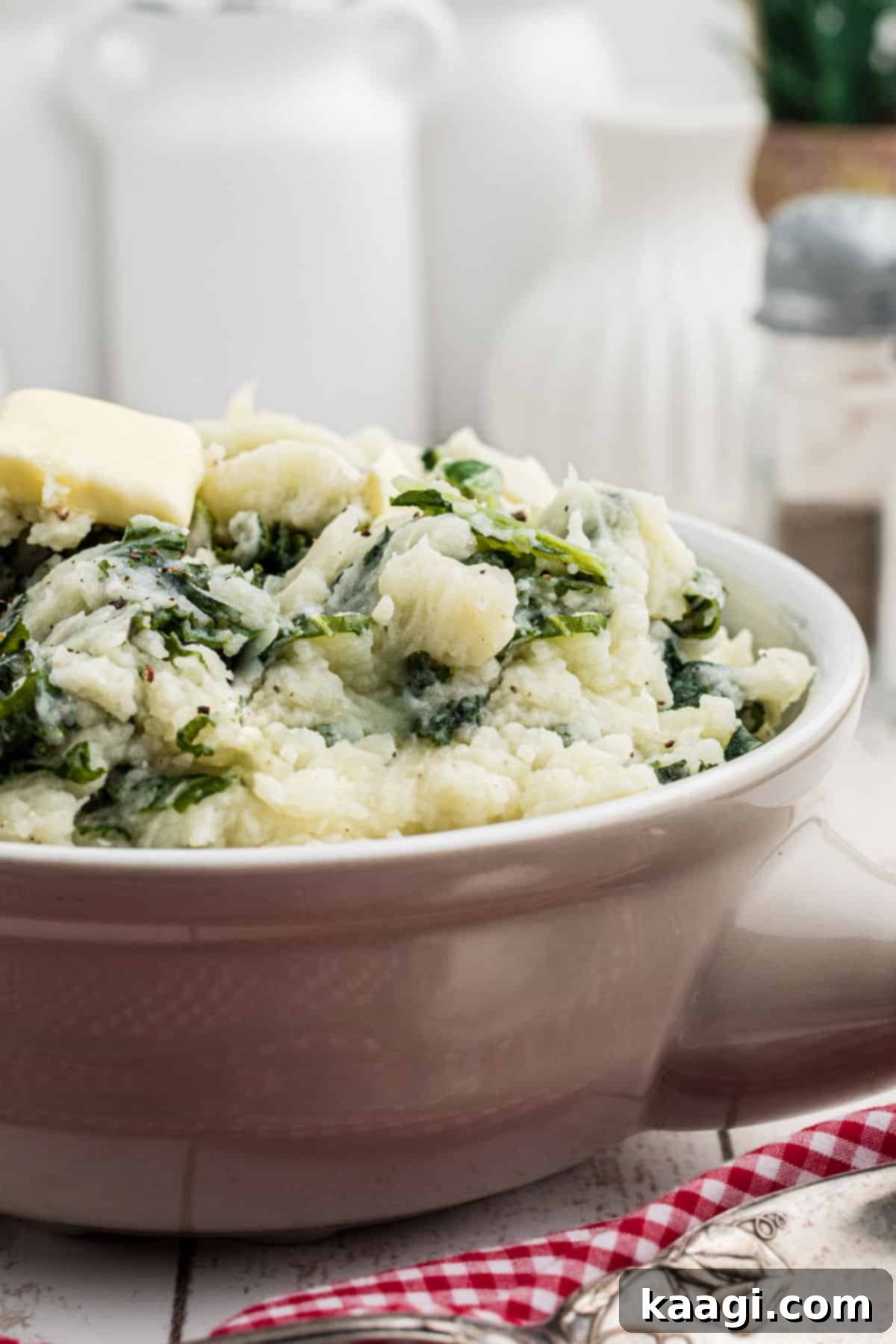 Close-up side view of a bowl of traditional Irish Colcannon, showing its creamy texture and bits of green kale or cabbage.