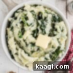 Overhead shot of a bowl of traditional colcannon with a butter slice melting on top.
