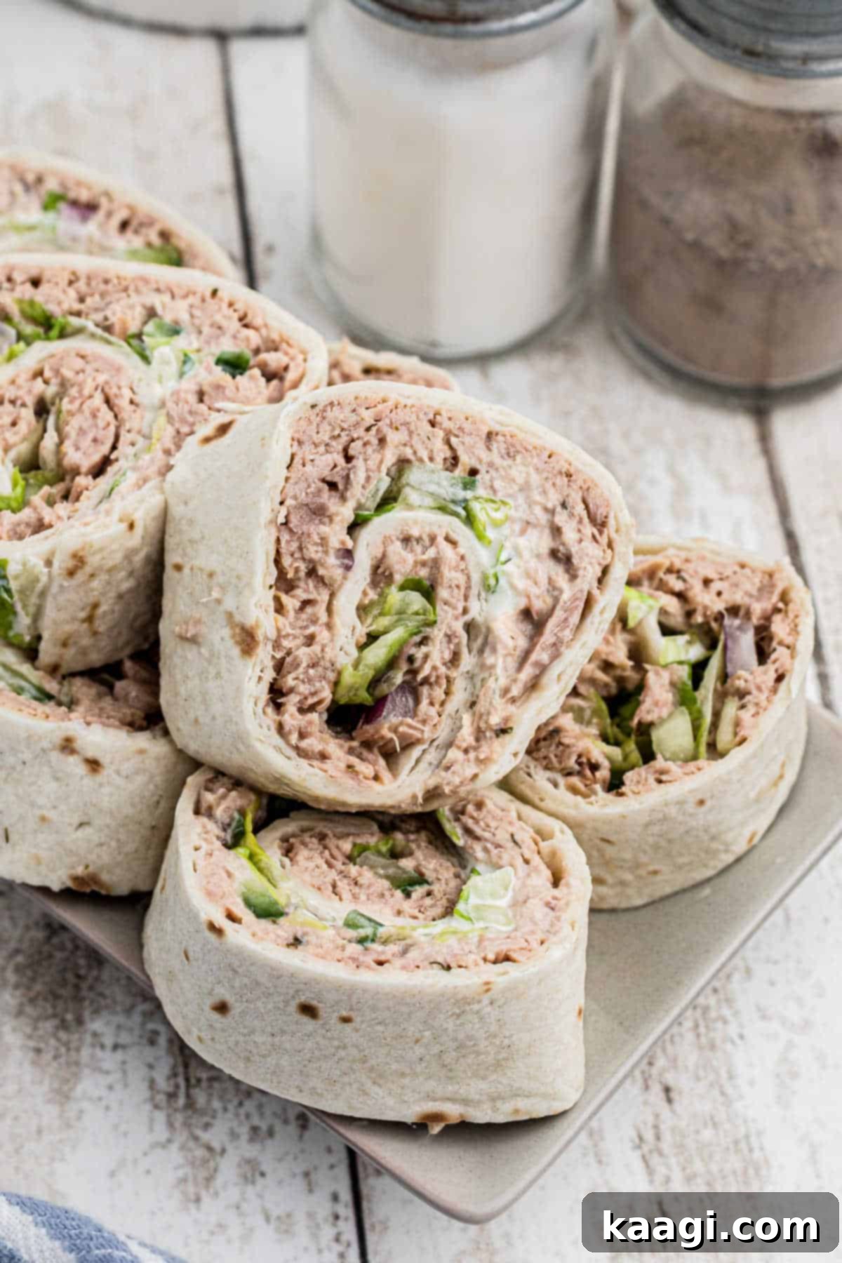Close-up image of fresh tuna pinwheels, perfectly sliced and arranged on a serving plate.