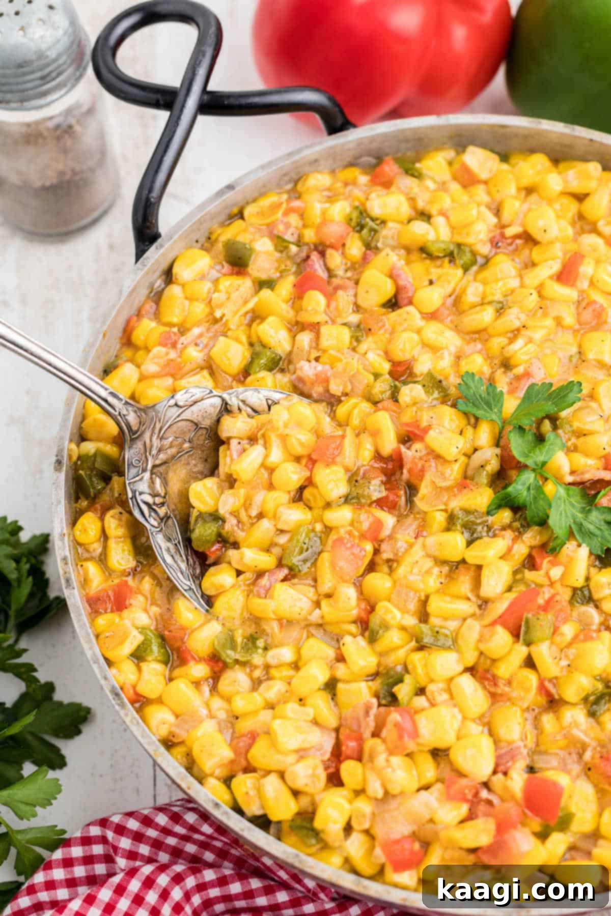 Side shot of a skillet full of cajun corn maque choux.