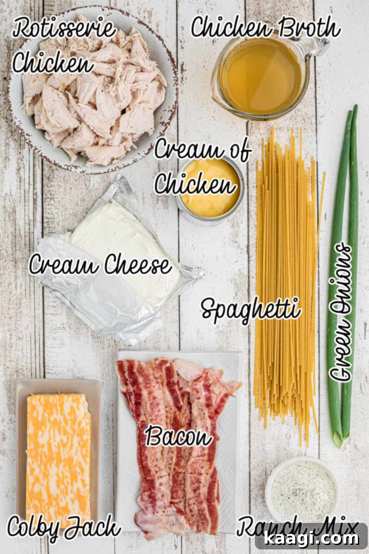 Creamy Slow Cooker Ranch Chicken Spaghetti 3 A collection of ingredients laid out on a table, including canned soups, cream cheese, ranch seasoning, and shredded chicken, essential for making Crock Pot Ranch Chicken Spaghetti.