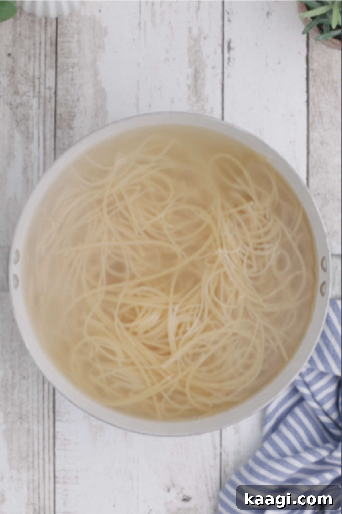 Creamy Slow Cooker Ranch Chicken Spaghetti 10 Cooked spaghetti noodles are shown in a pot, perfectly al dente and ready to be incorporated into a dish.