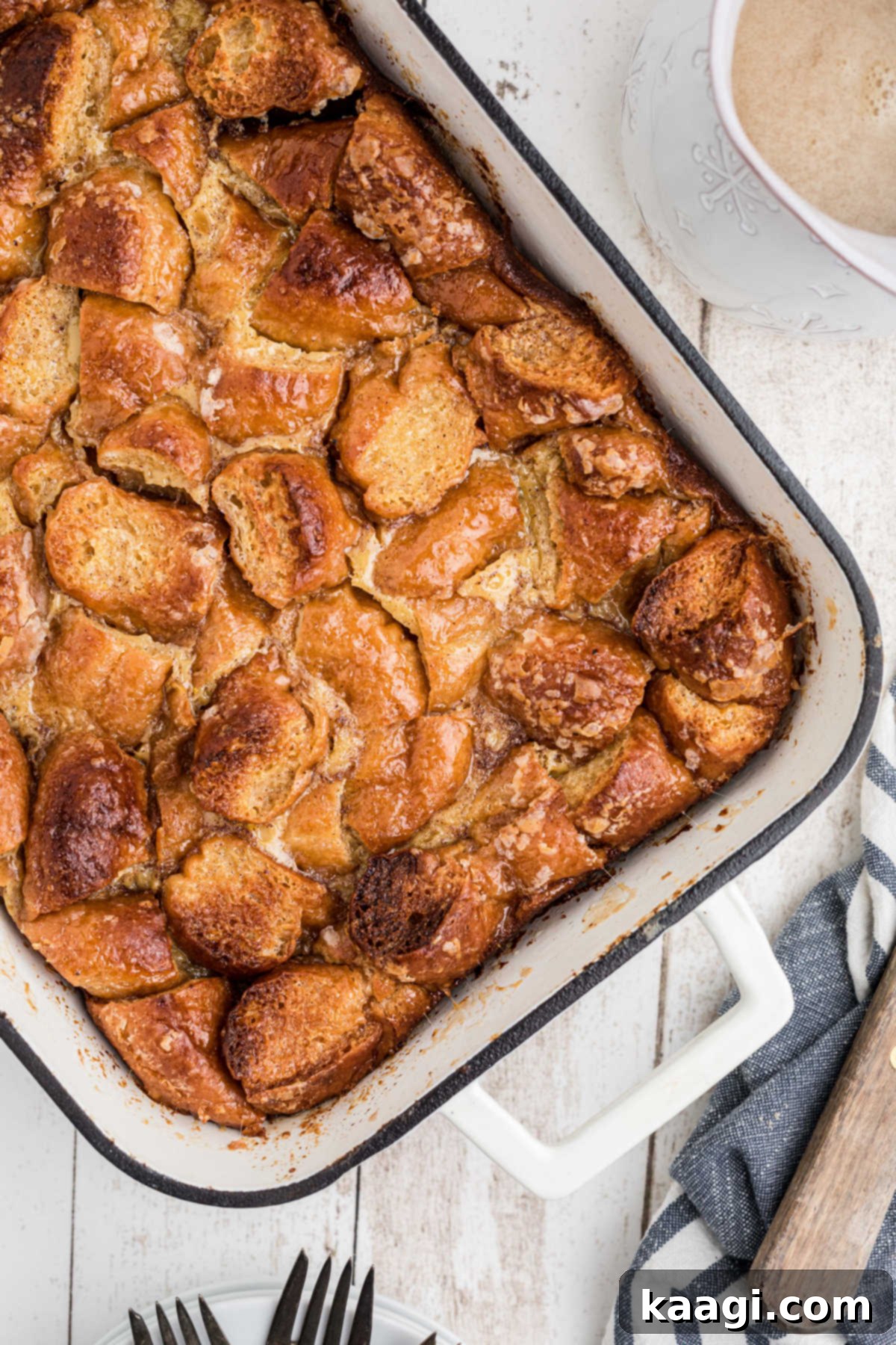 An inviting overhead shot showcasing a full baking pan of perfectly golden-brown Krispy Kreme bread pudding, ready to be served.