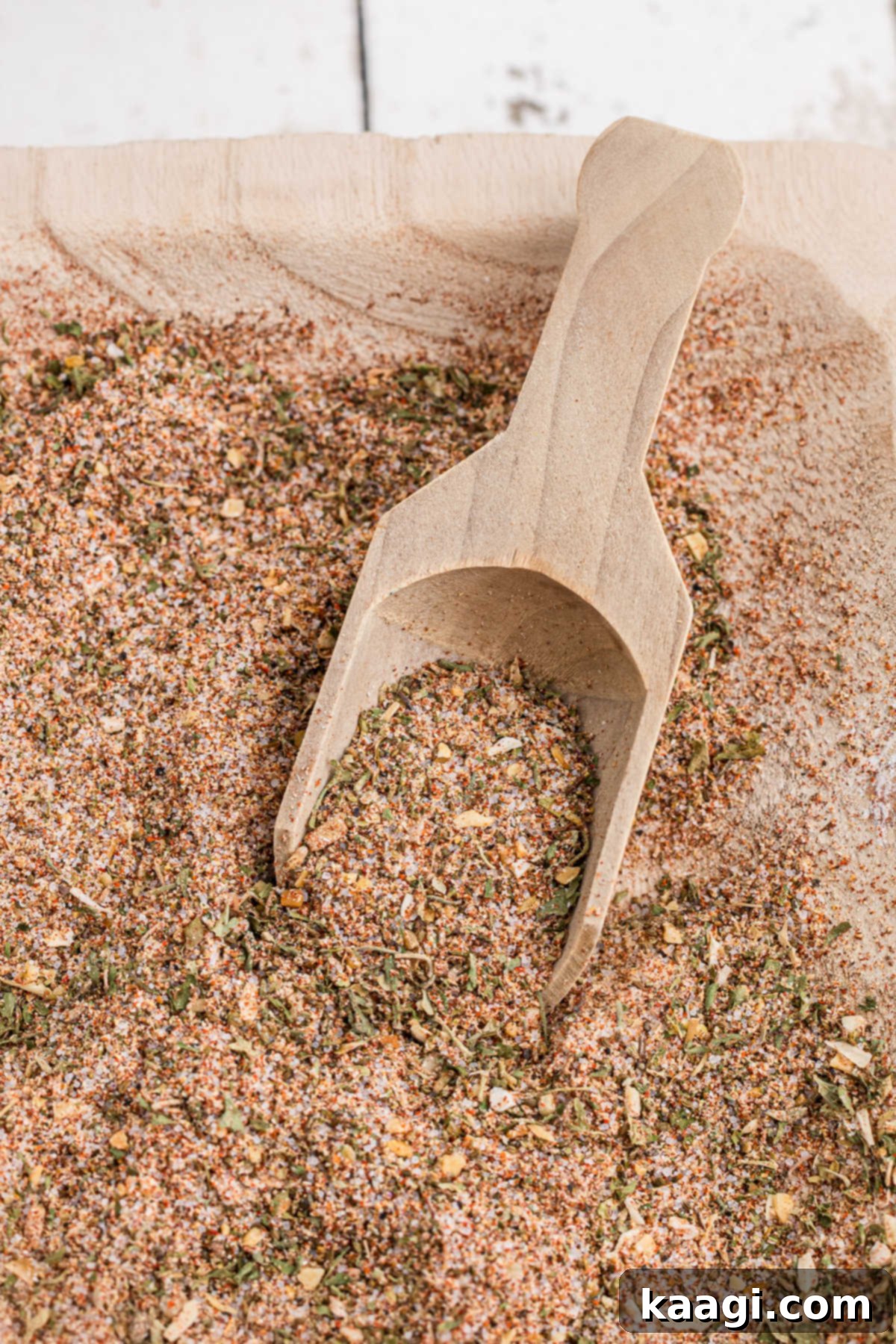 Close up shot of a wooden bowl with mixed all purpose seasoning.