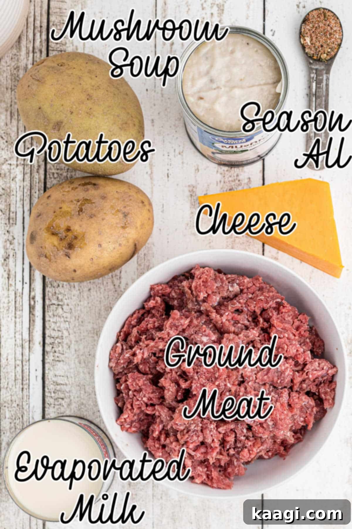 Homestyle Beef and Potato Casserole 3 An overhead shot of various ingredients laid out on a kitchen counter, including ground beef, whole potatoes, a block of cheddar cheese, cans of soup and milk, and a seasoning shaker, all ready for the hamburger potato casserole.
