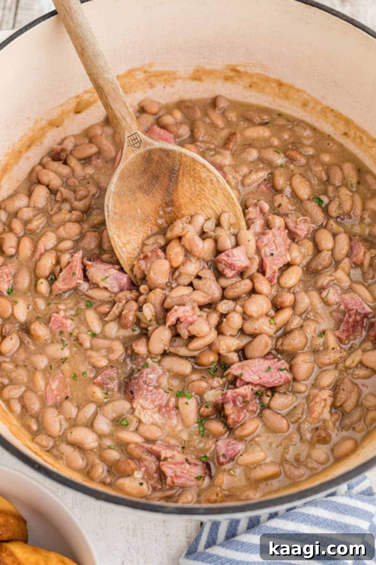 Close up of a pot of pinto beans simmering, showing the rich, creamy texture and depth of color.