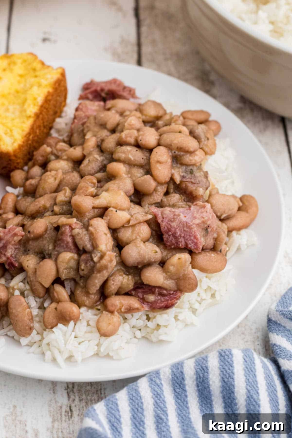 Side view of a plate of pinto beans and rice, ready to be enjoyed, showcasing the hearty meal.