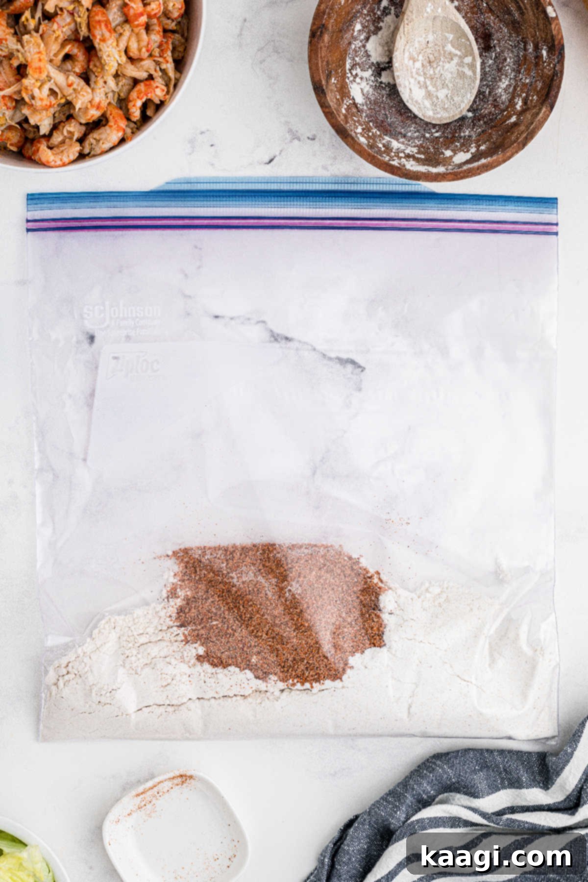 A resealable bag filled with flour and seasonings.