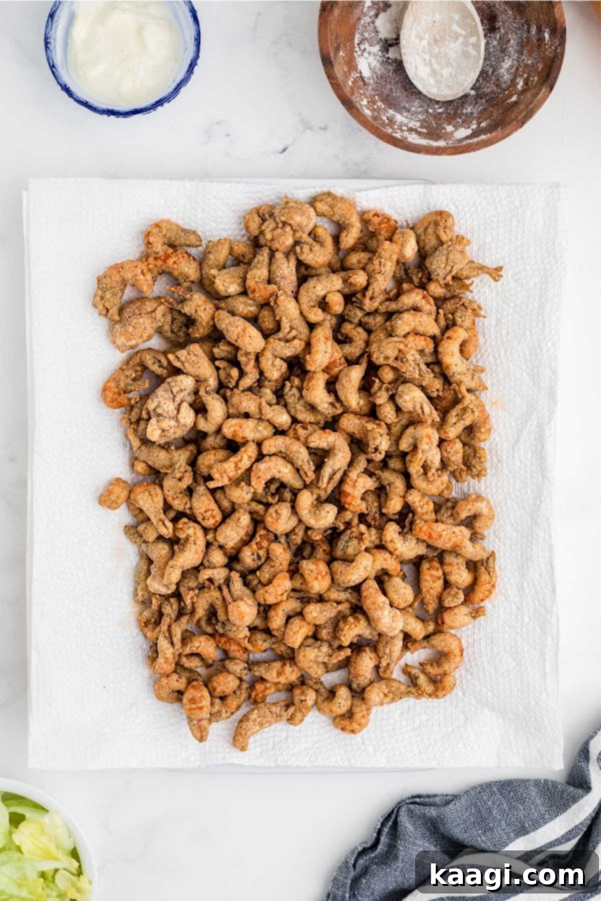 A plate full of fried crawfish, on paper towels.