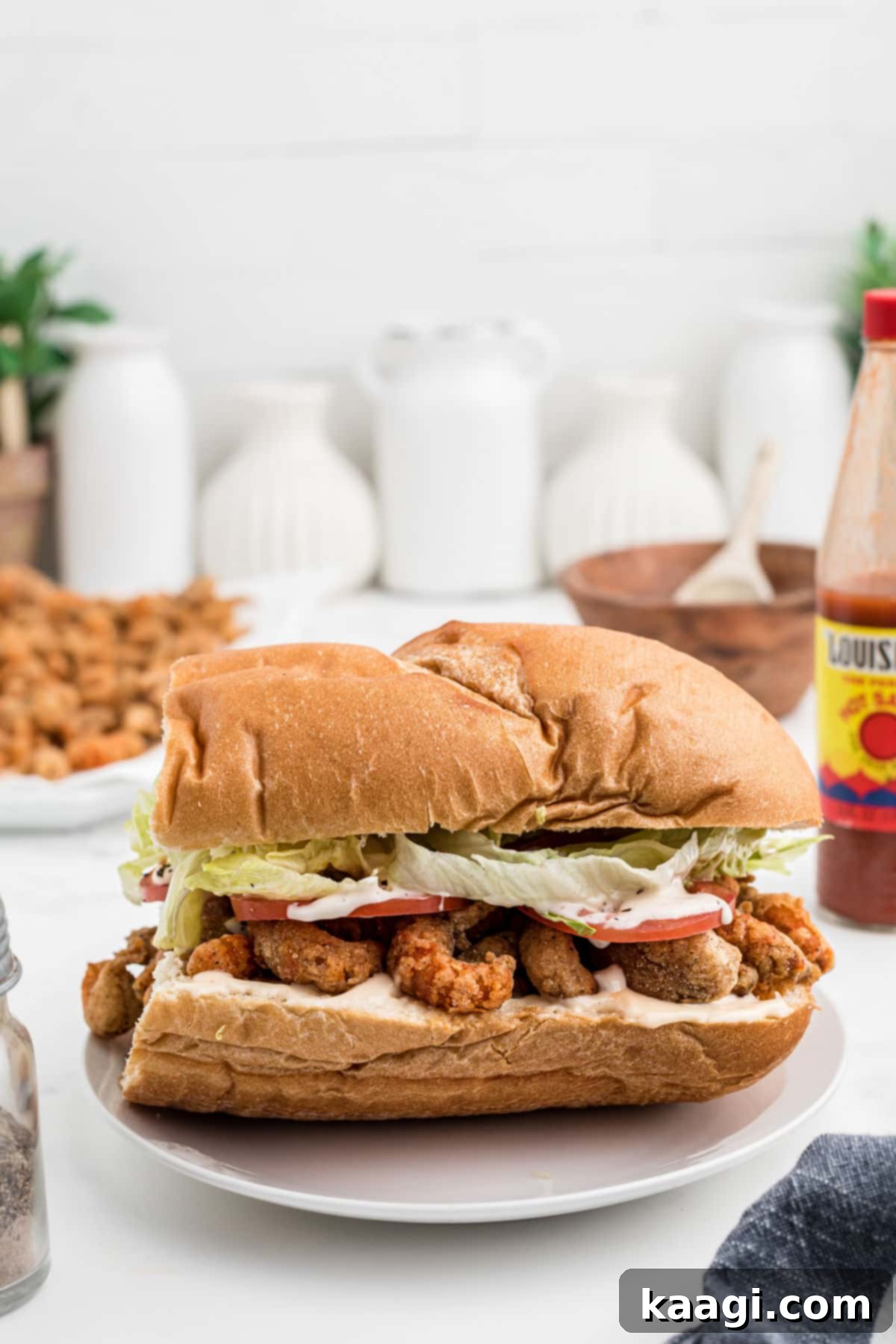 Side view of a closed dressed fried crawfish poboy.