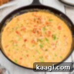 Side view of a skillet full of crawfish sauce.