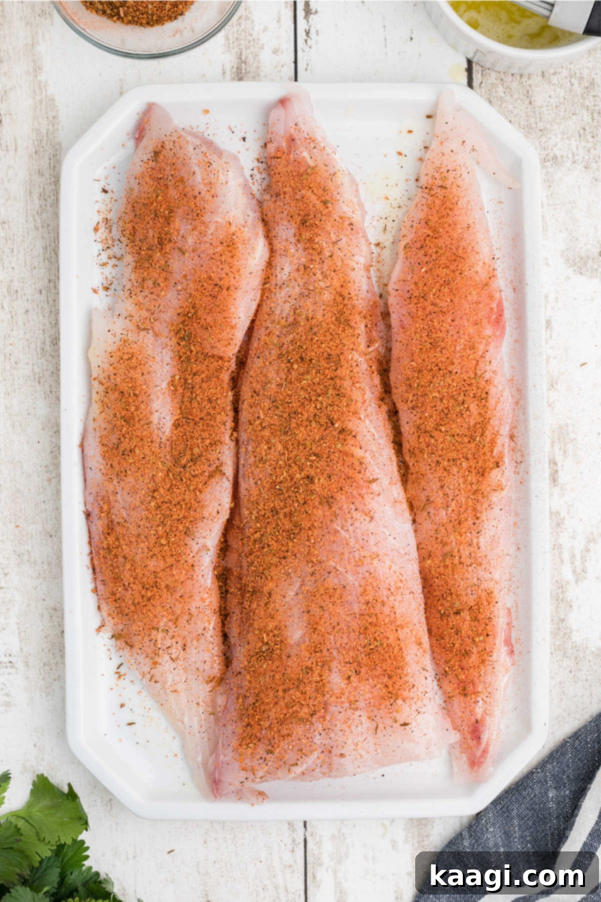 Smoky Cajun Redfish 6 Redfish fillets liberally seasoned with a dark blackening spice, pressed firmly to ensure maximum flavor penetration.
