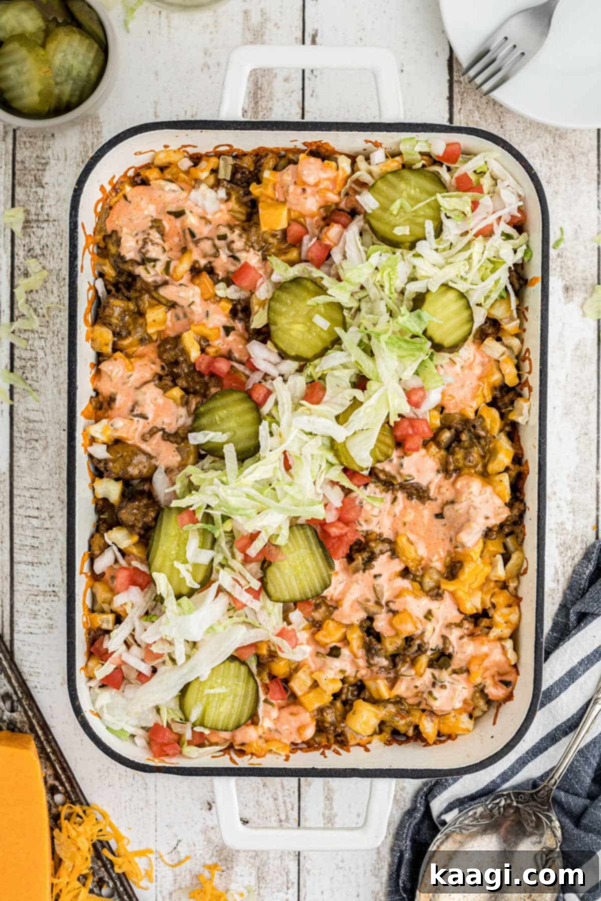 Ultimate Big Mac Comfort Casserole 2 Overhead shot of a big mac casserole with lettuce and pickles down the middle.