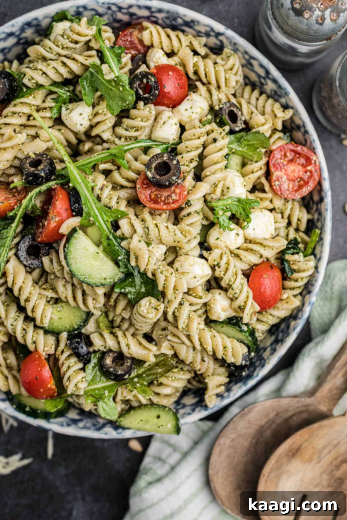 Vibrant Pesto Vinaigrette 7 A pesto dressing being used to create a delicious pesto pasta salad, showcasing its versatility.