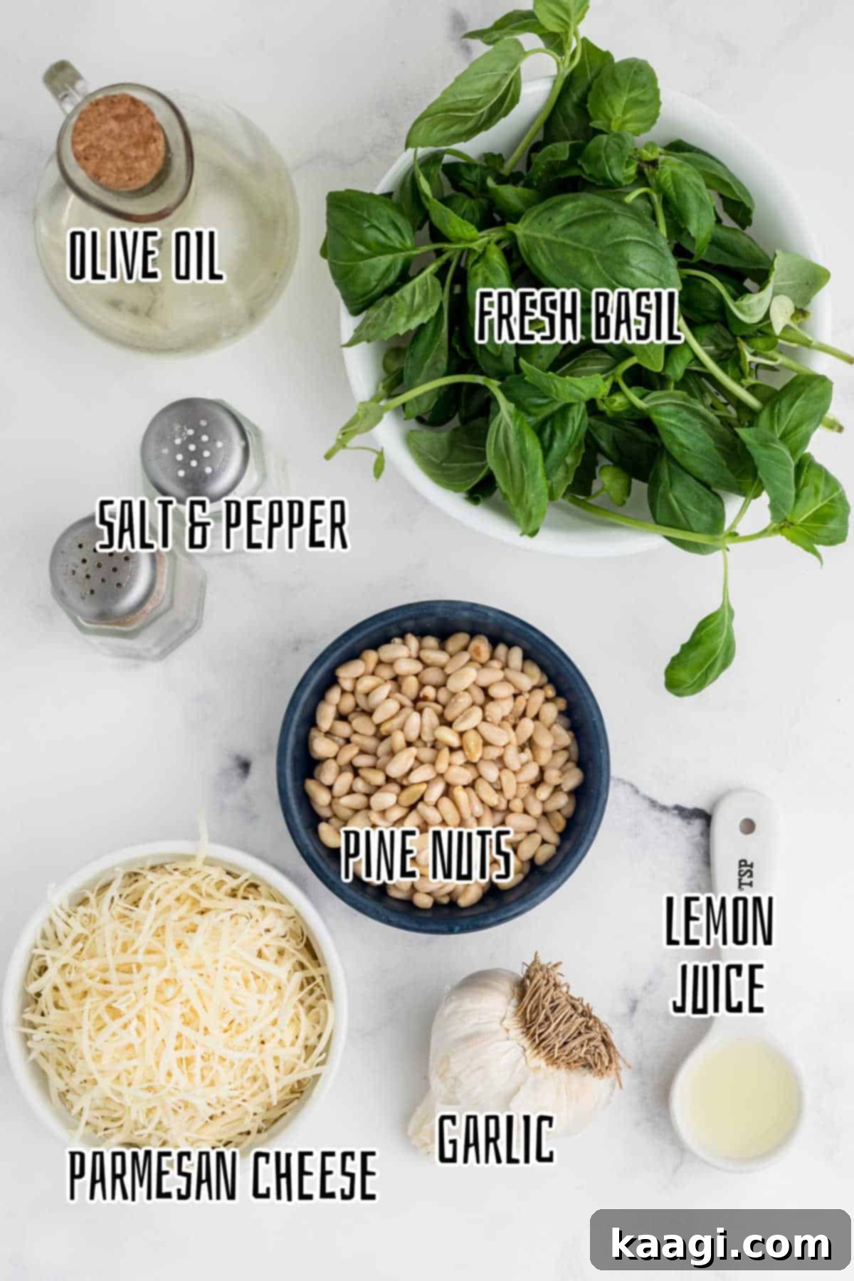 Vibrant Pesto Vinaigrette 3 Overhead shot of fresh ingredients laid out for making pesto dressing, including basil, pine nuts, Parmesan, garlic, lemon, and olive oil.