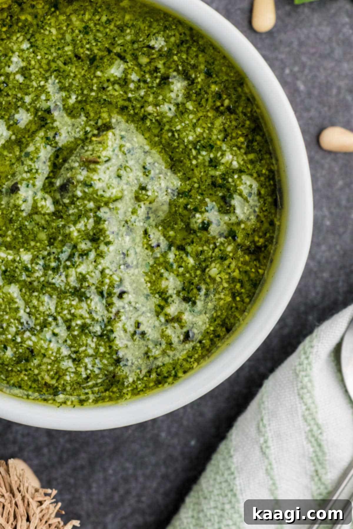Vibrant Pesto Vinaigrette 5 Overhead close-up shot of a small bowl filled with vibrant green pesto dressing, ready to be served.