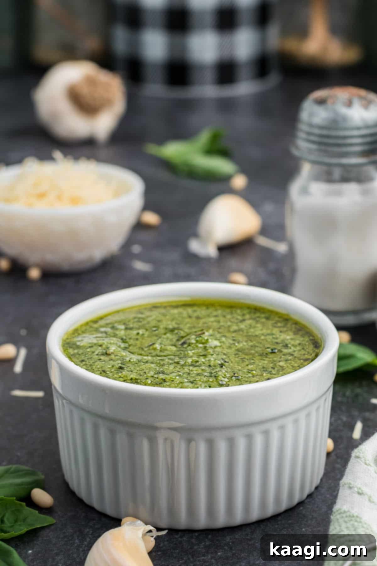 Vibrant Pesto Vinaigrette 6 Side shot of a bowl of vibrant green pesto dressing, highlighting its creamy texture.