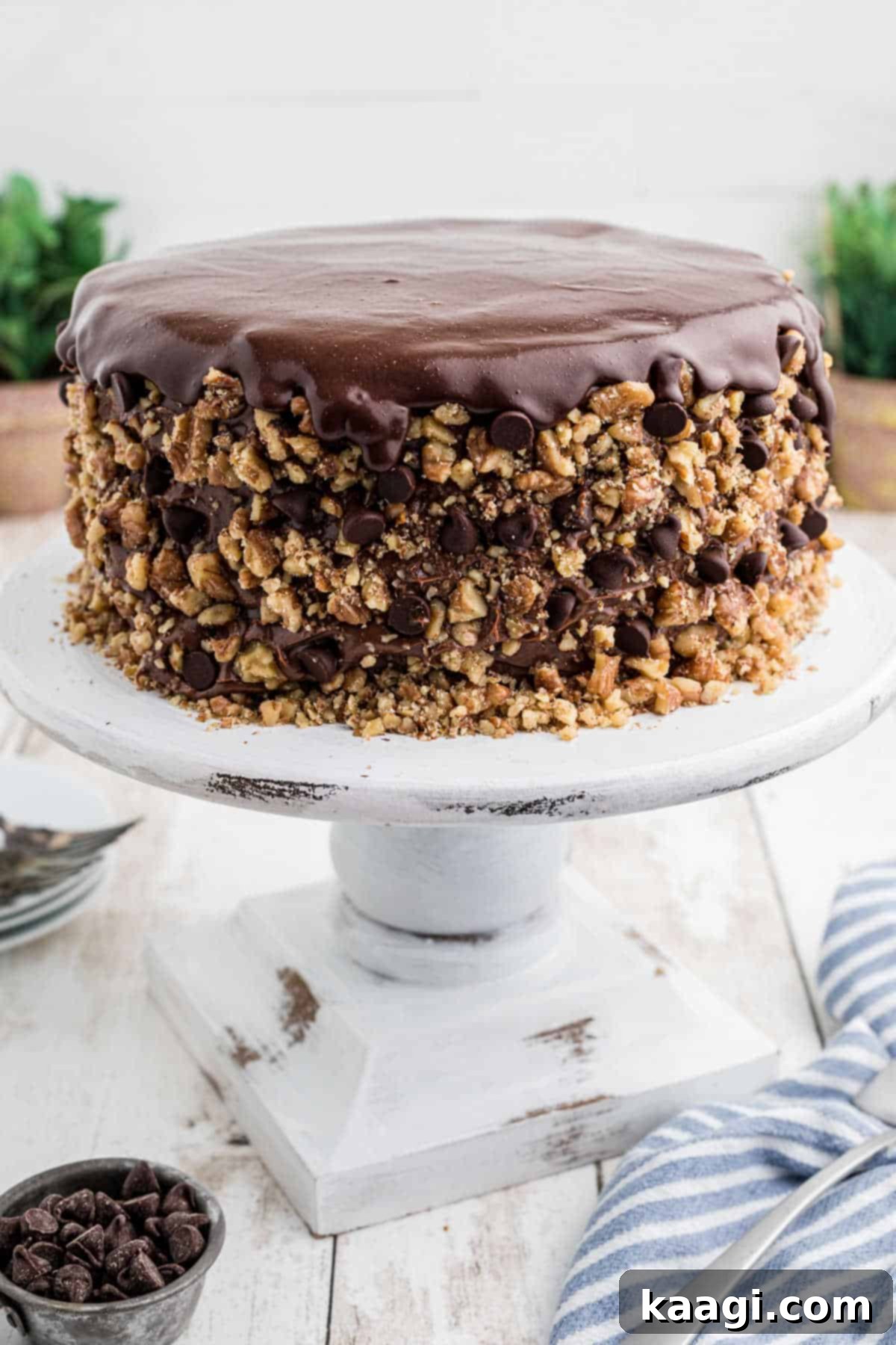 Decadent Banana Dream Cake on a white cake stand, ready to be served, showcasing its beautiful layers.
