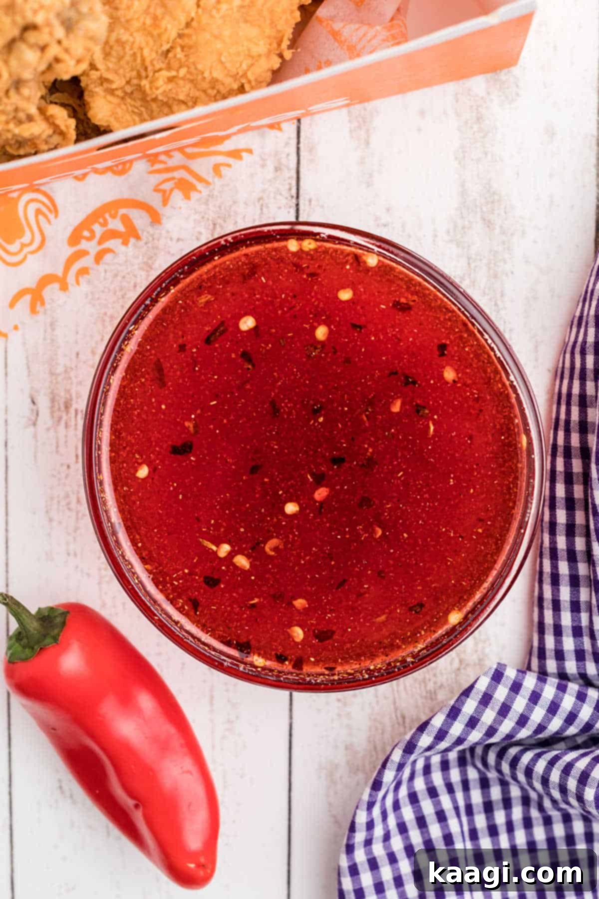 Overhead shot of a bowl of homemade Popeyes sweet heat sauce recipe, ready to serve.
