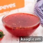 Close up of a bowl of homemade Popeyes sweet heat sauce recipe.