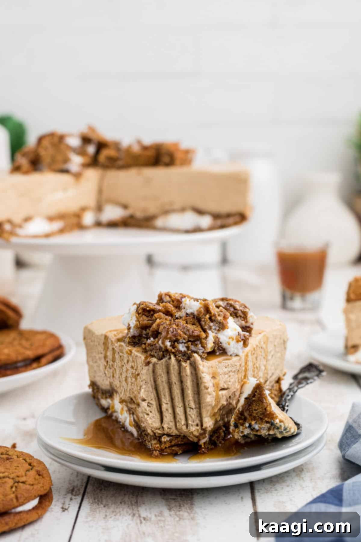A slice of oatmeal creme pie cheesecake with a fork mark through the front, showcasing its creamy layers and cookie crust.
