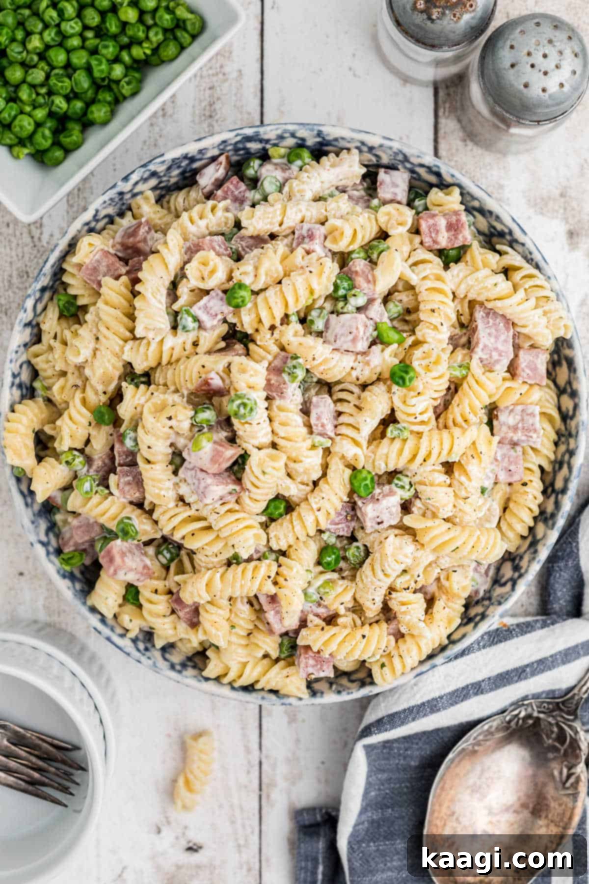 Overhead shot of a vibrant bowl of Ruby Tuesday Ham and Pea Pasta Salad, garnished and ready to be enjoyed.