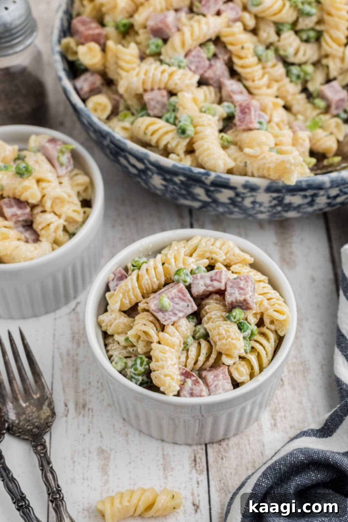A perfectly dished up serving of Ruby Tuesday's Ham and Pea pasta salad in a white bowl.