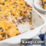 Side shot of a hamburger hashbrown casserole, cropped square.