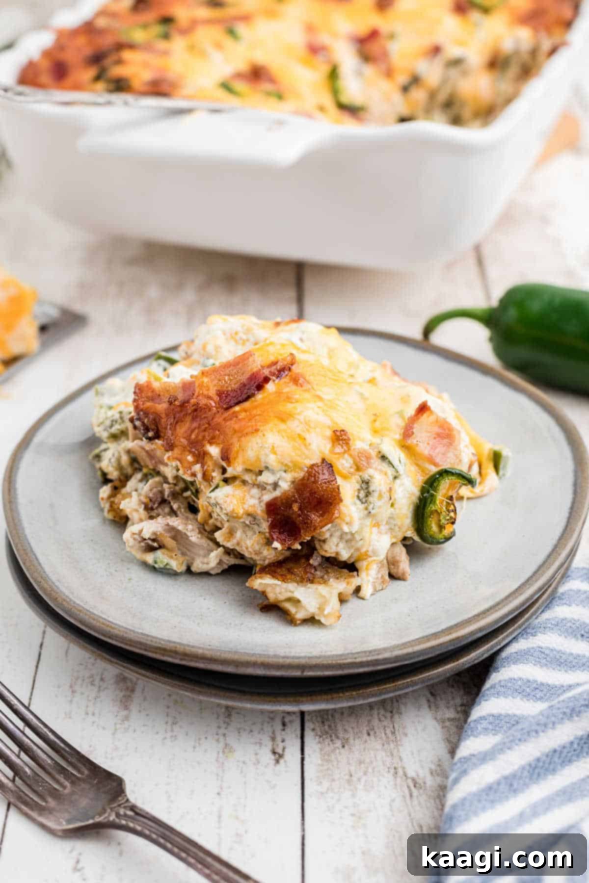 A close-up shot of a full casserole dish, brimming with creamy, cheesy Jalapeno Popper Tater Tot Casserole, ready to be served.
