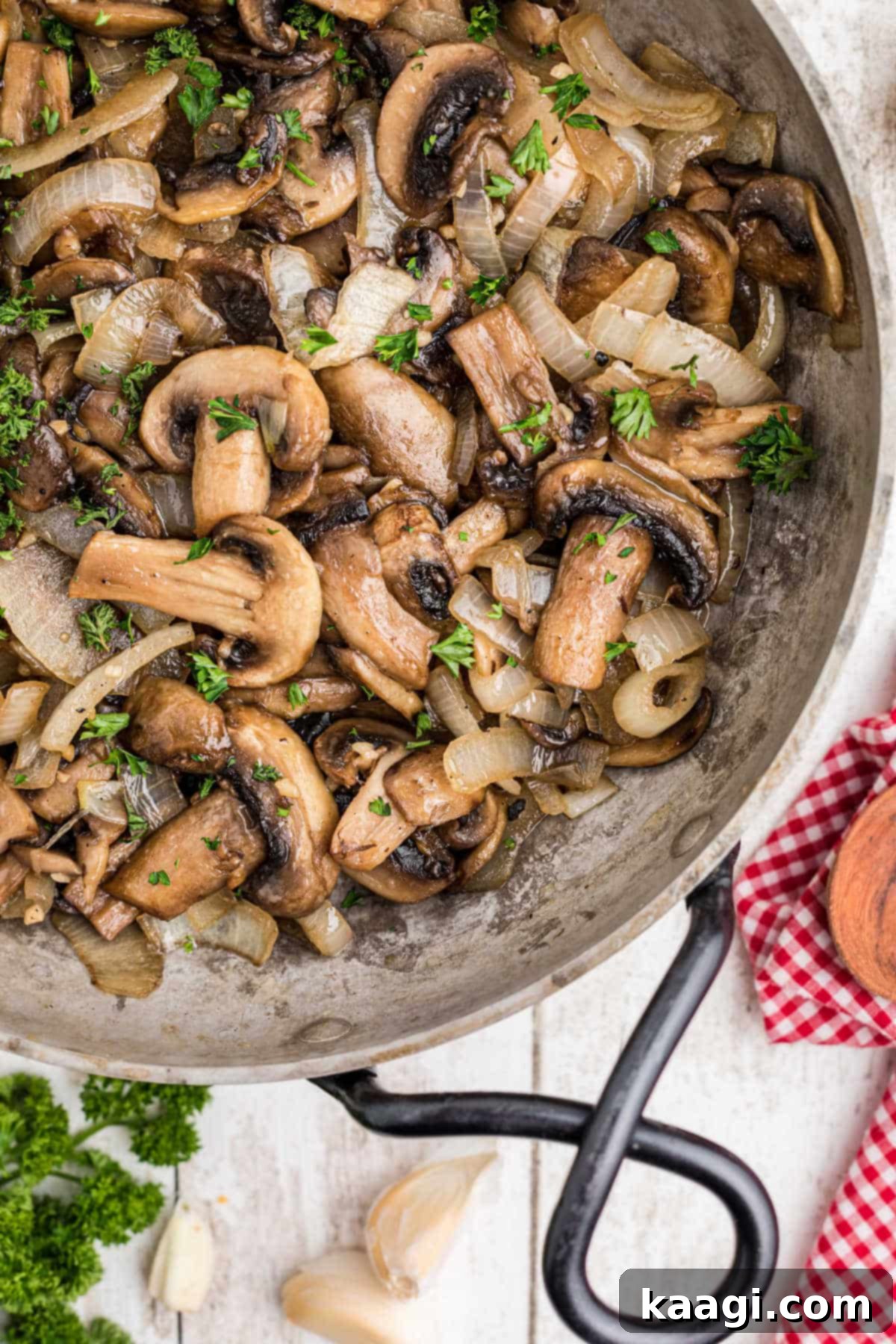 A high-angle, close-up view of a skillet brimming with Texas Roadhouse Sauteed Mushrooms, highlighting their glistening surface and tender appearance.