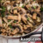 Close up of a skillet with Texas Roadhouse Sauteed Mushrooms inside.