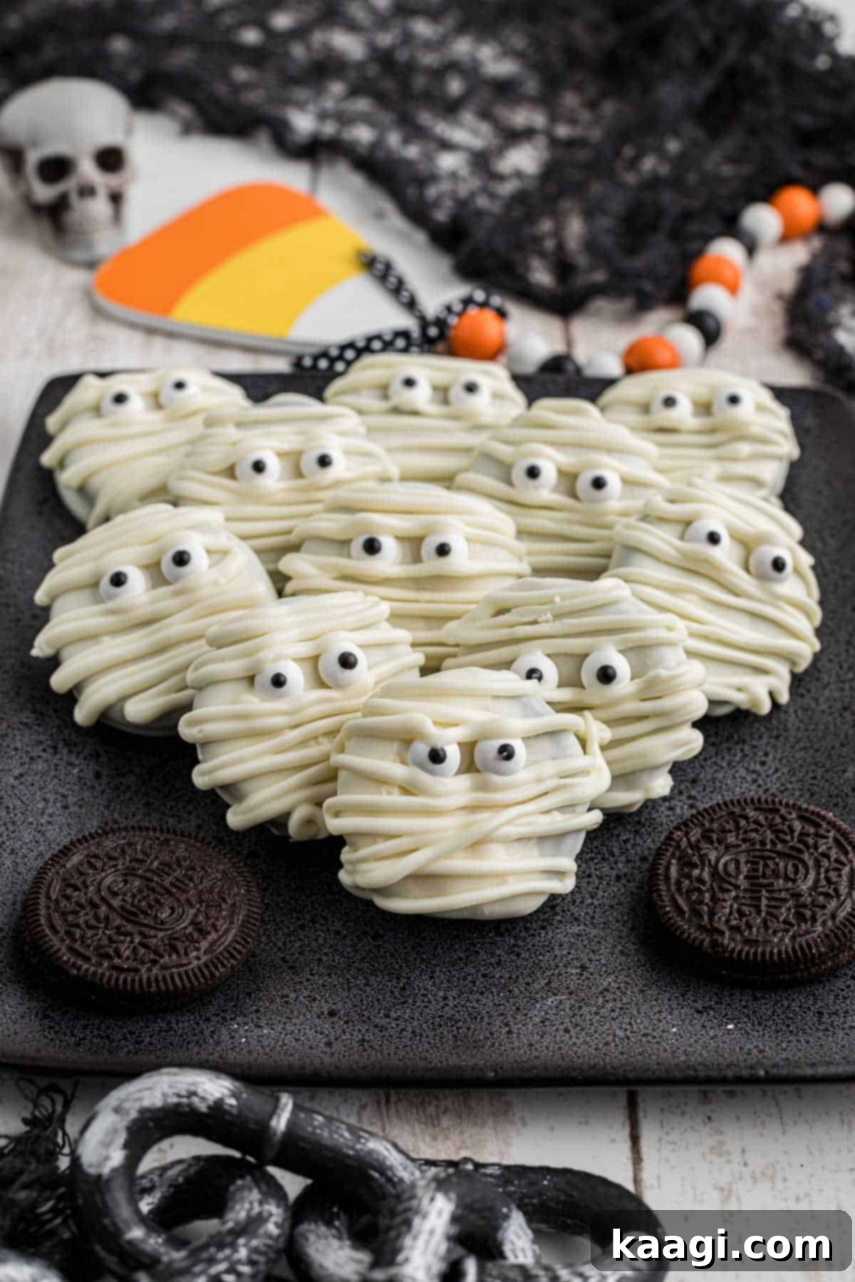 Mummy Oreos stacked against each other and decorated for Halloween, showcasing their cute, spooky design.