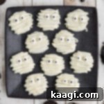 Overhead shot cropped square, of a square plate of mummy oreos.