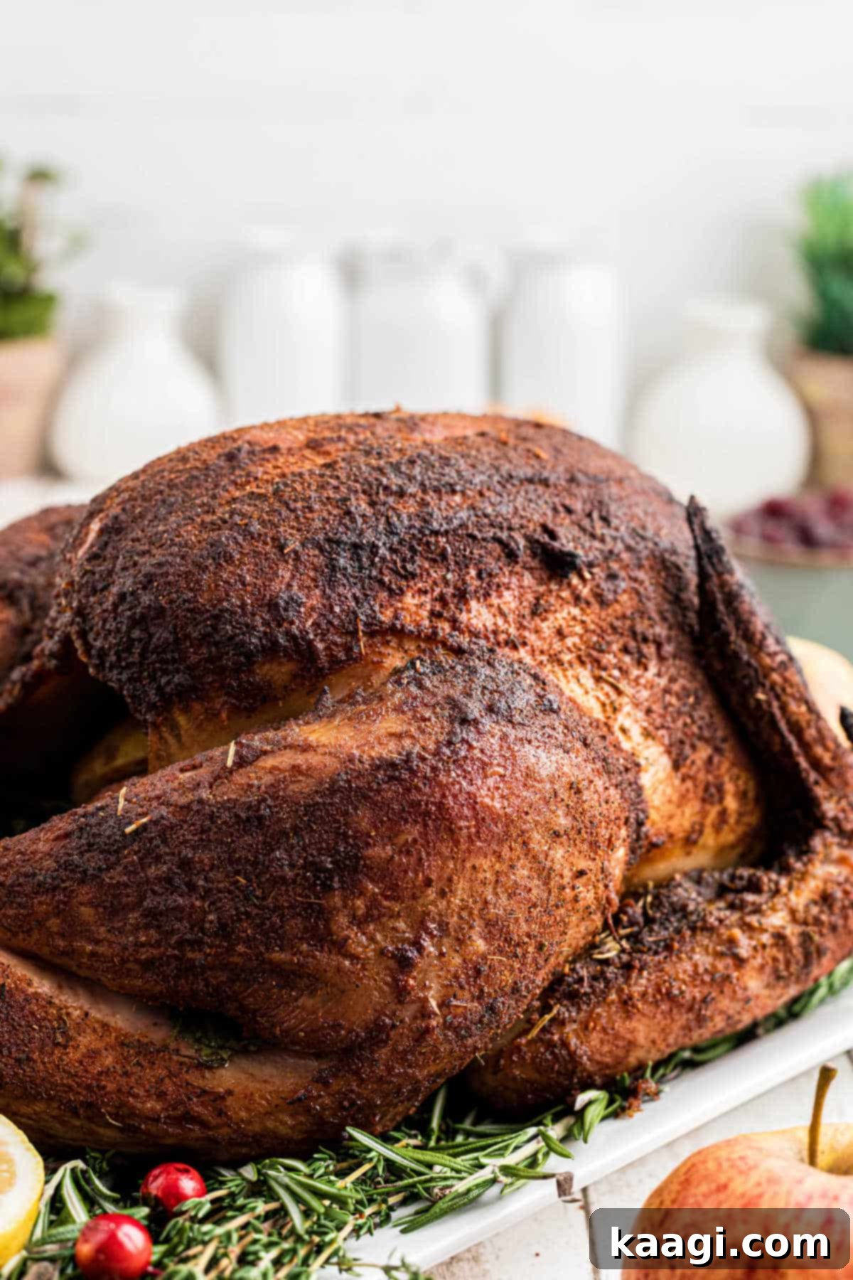 Side shot of a smoked turkey that has been seasoned with a smoked turkey rub recipe, showcasing crispy skin.