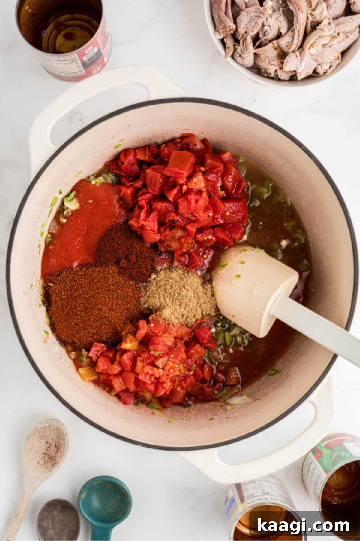 Rich and Hearty Dutch Oven Turkey Chili 5 Tomatoes and seasonings added to a Dutch oven.