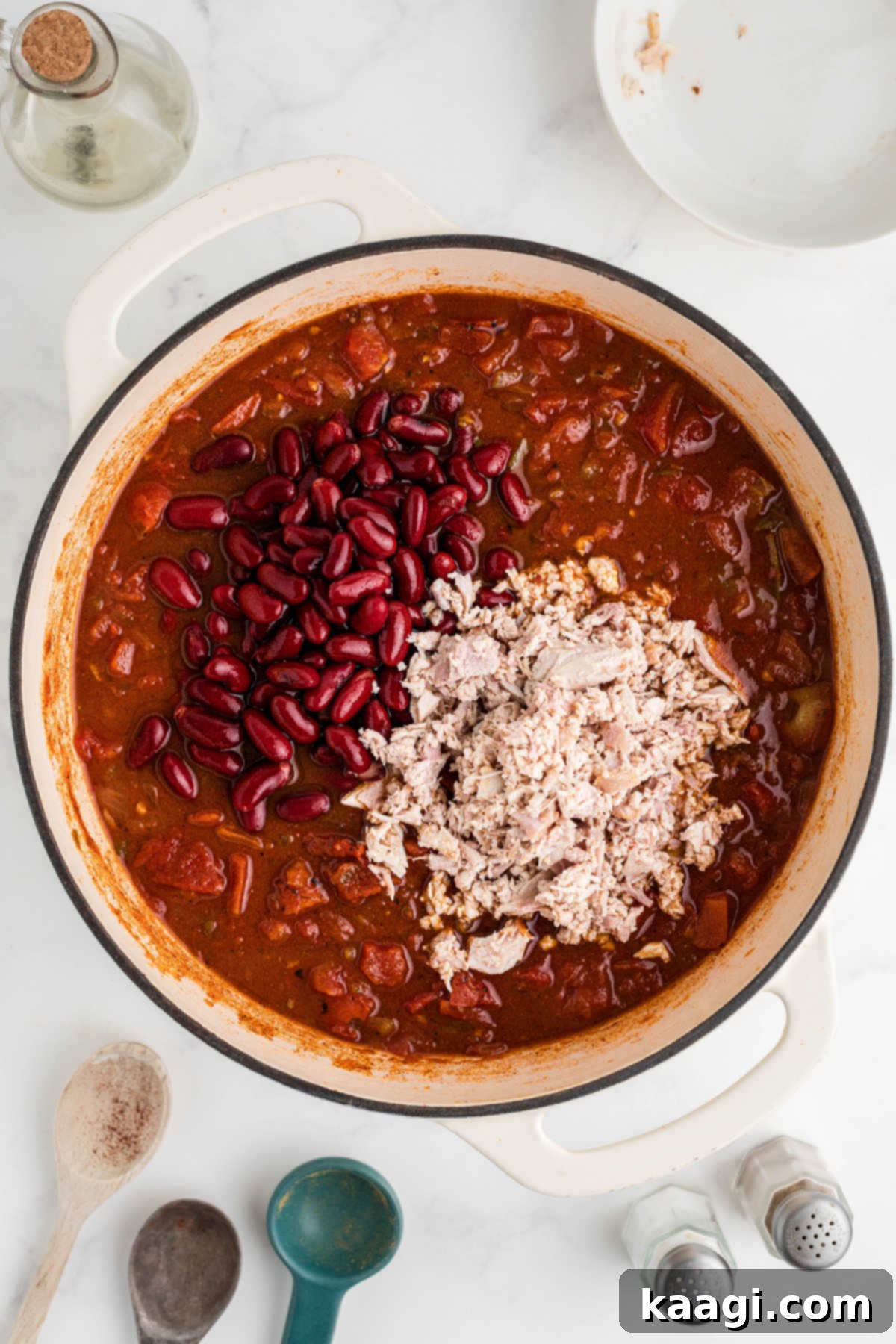 Rich and Hearty Dutch Oven Turkey Chili 7 Ground turkey added to a large Dutch Oven with a chili.