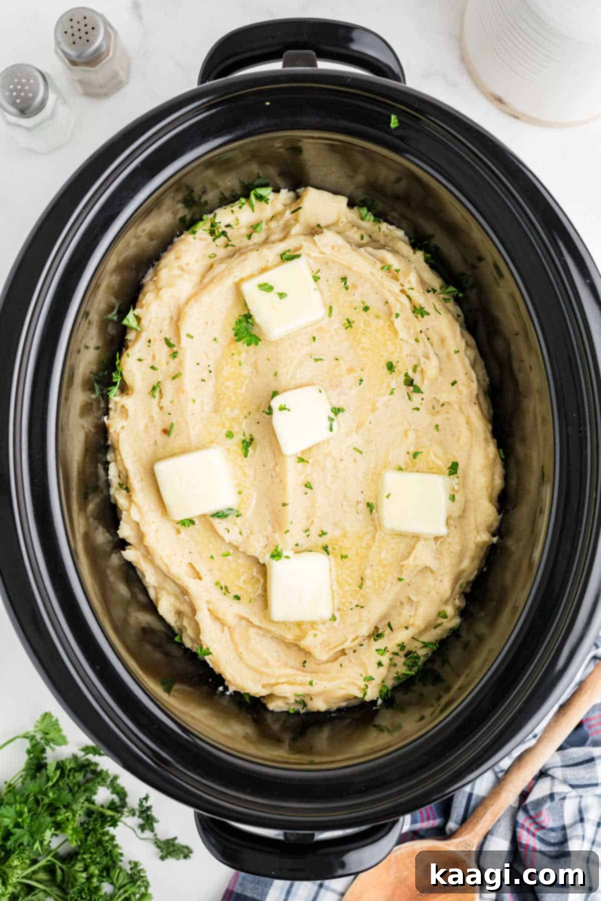 Savory Slow Cooker Mashed Potatoes 2 Overhead image of a slow cooker with mashed potatoes made with chicken broth.