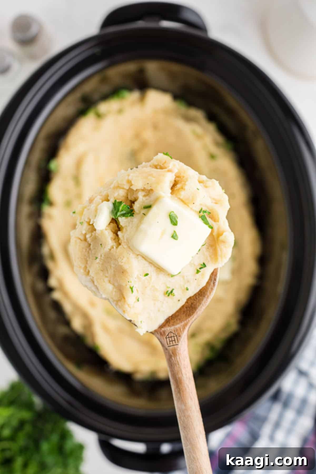 Savory Slow Cooker Mashed Potatoes 10 Crock Pot Mashed Potatoes, a spoon scooping some out.