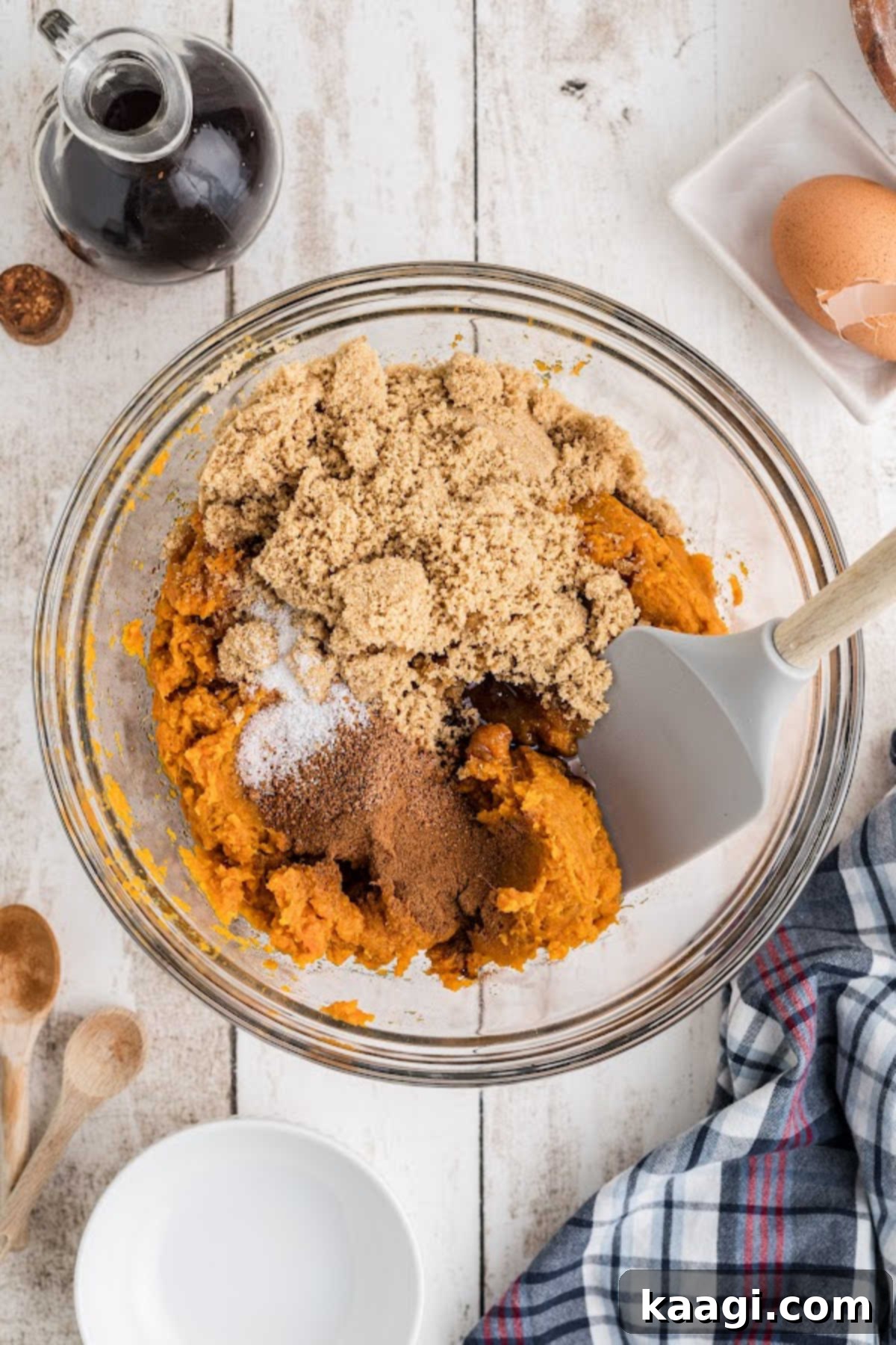 Sweet potatoes and sugar and cinnamon in a mixing bowl.