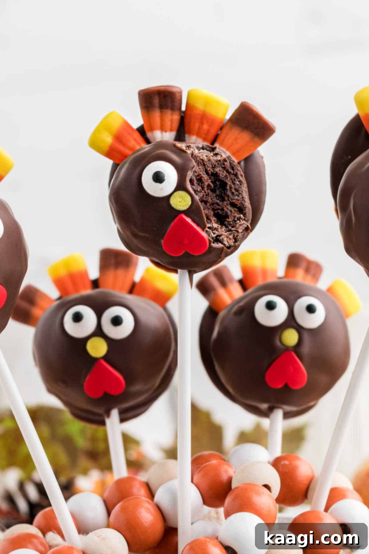 Festive Thanksgiving Cake Pops 2 Close up of a delightful Thanksgiving cake pop shaped like a turkey, with a bite playfully taken out.