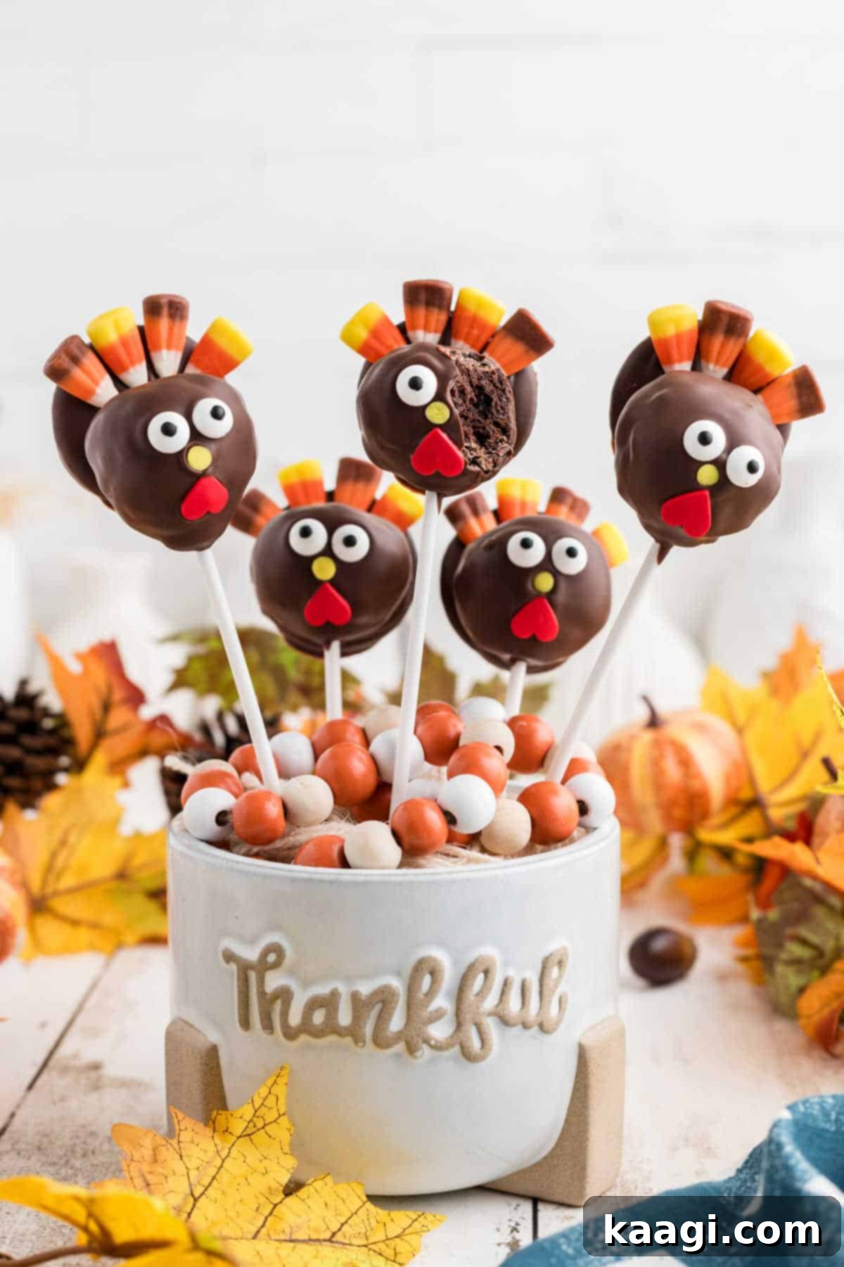 Festive Thanksgiving Cake Pops 11 A festive Thanksgiving cake pop recipe, with one finished turkey cake pop showing a delightful bite taken out.