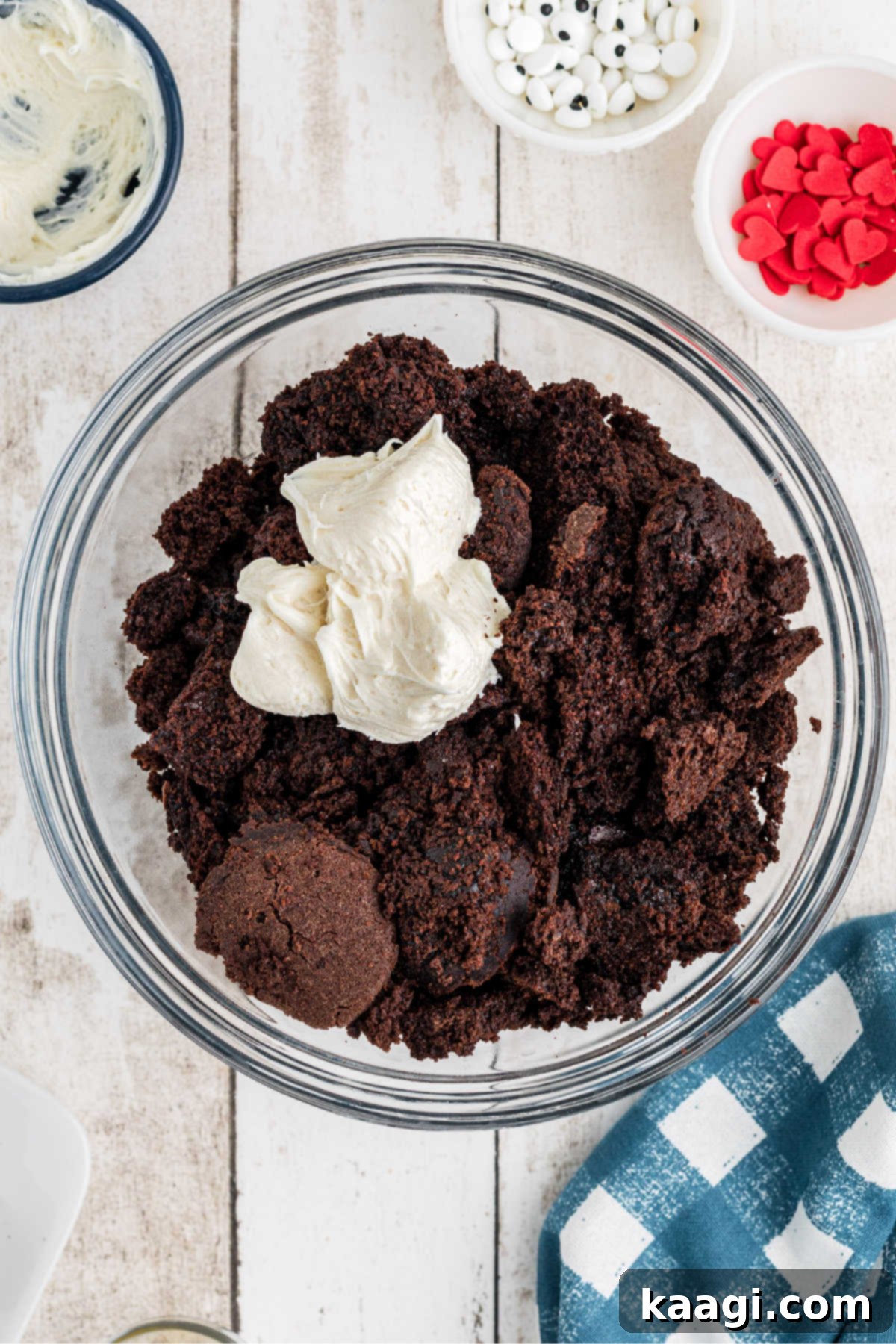 Festive Thanksgiving Cake Pops 5 Crumbled cake crumbs being thoroughly mixed with creamy frosting in a large mixing bowl.