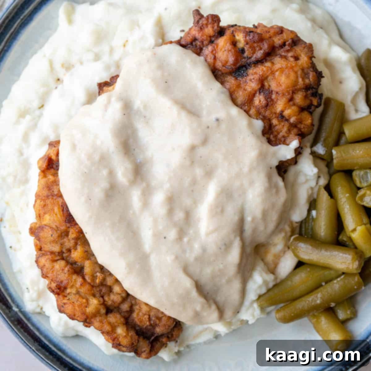 Southern Skillet Classics 8 A perfectly cooked Old Fashioned Chicken Fried Steak, golden and crispy, likely served with creamy white gravy.