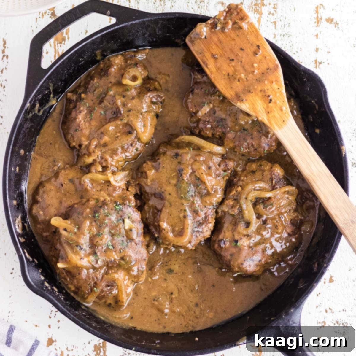 Southern Skillet Classics 13 Seasoned hamburger steaks simmered in a rich onion gravy, a homestyle dish reminiscent of Cracker Barrel.