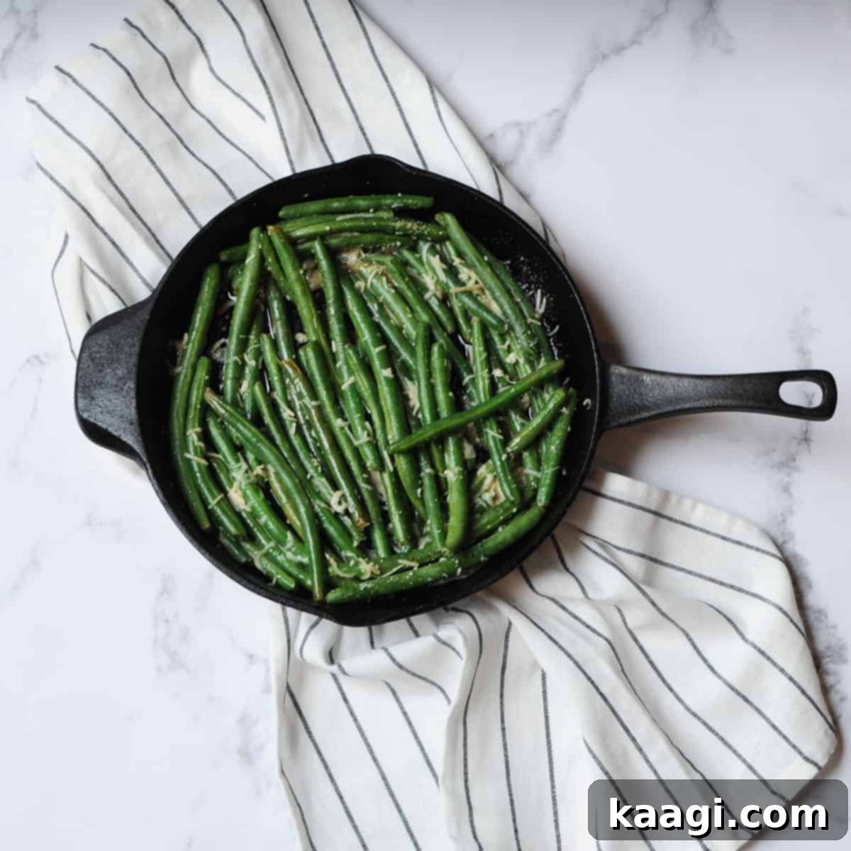 Southern Skillet Classics 38 Fresh green beans cooked in a cast iron skillet with spices, lemon, and Parmesan cheese, a super easy and flavorful side.