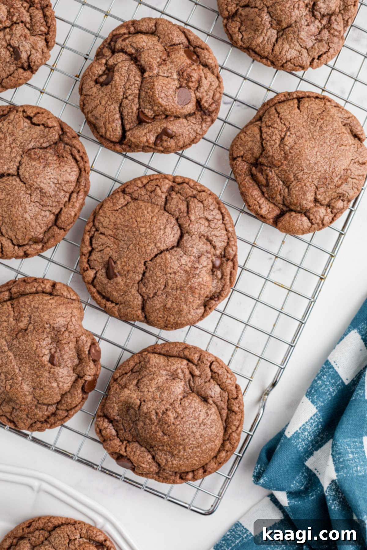 Close up of some Nutella brownie Cookies on a wire rack, showing their rich color and texture.