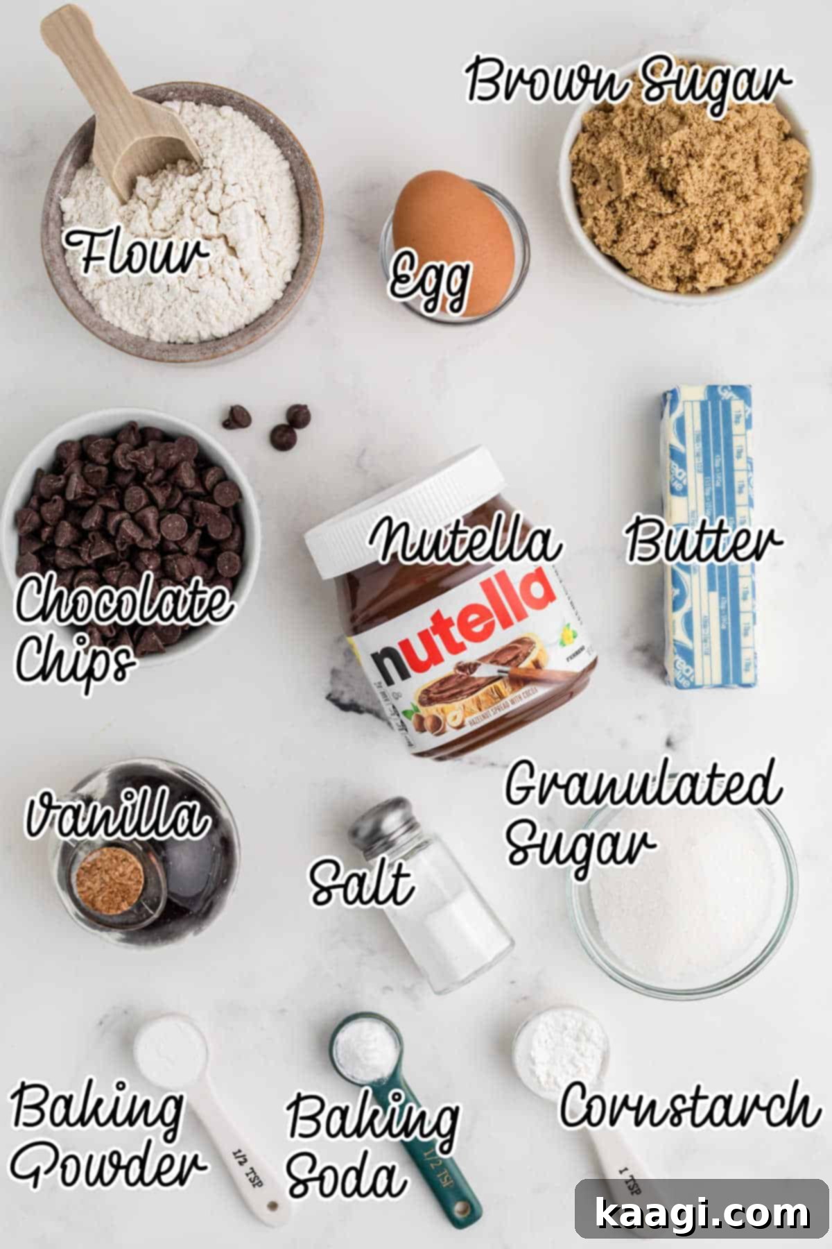 Ingredients laid out on a counter, including butter, sugar, Nutella, eggs, flour, and chocolate chips.