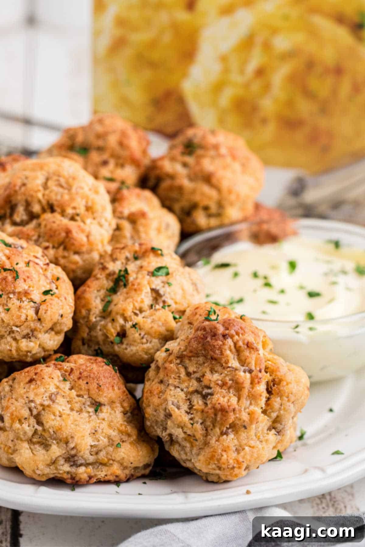 Cheddar Bay Sausage Bites 2 Side angled shot of a plate full of cheddar bay sausage balls, perfectly golden brown.