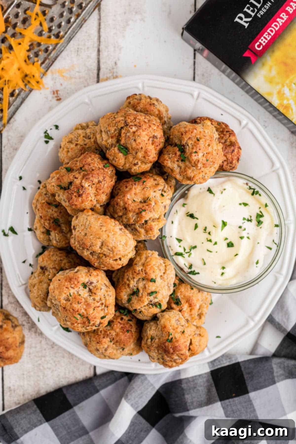 Cheddar Bay Sausage Bites 9 Overhead shot of a plate full of cheddar bay sausage balls with a small bowl of ranch dip on the side.