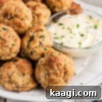 Cheddar Bay Sausage Bites 10 Close up of some cheddar bay sausage balls with ranch in a bowl.